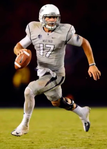 Nevada quarterback Cody Fajardo, 2011-2015, scrabbles on the field during a football game. 