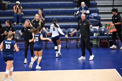 Head Coach Jason Borchin and staff get Masyn Navarro (#8), Lara Pacheco (#15), and Paige Thies (#10) ready before UTEP on Oct. 10 at the Virginia Street Gym.
